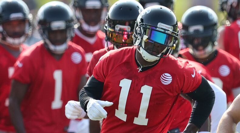 Falcons wide receiver Julio Jones runs a agility drill the first day of team practice at training camp on Thursday, July 27, 2017, in Flowery Branch.