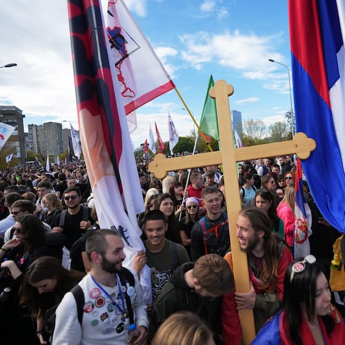 People gather, among them students, to walk on the street towards the northern city of Novi Sad, for a huge rally on Nov. 1 marking the first anniversary of a train station disaster that killed 16 people, in Belgrade, Serbia, Thursday, Oct. 30, 2025. (AP Photo/Darko Vojinovic)