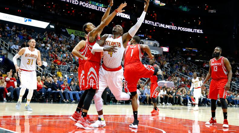 Atlanta Hawks forward Paul Millsap (4) shoots during the first half of an NBA basketball game against the Houston Rockets on Saturday, Nov. 5, 2016, in Atlanta. (AP Photo/Todd Kirkland)