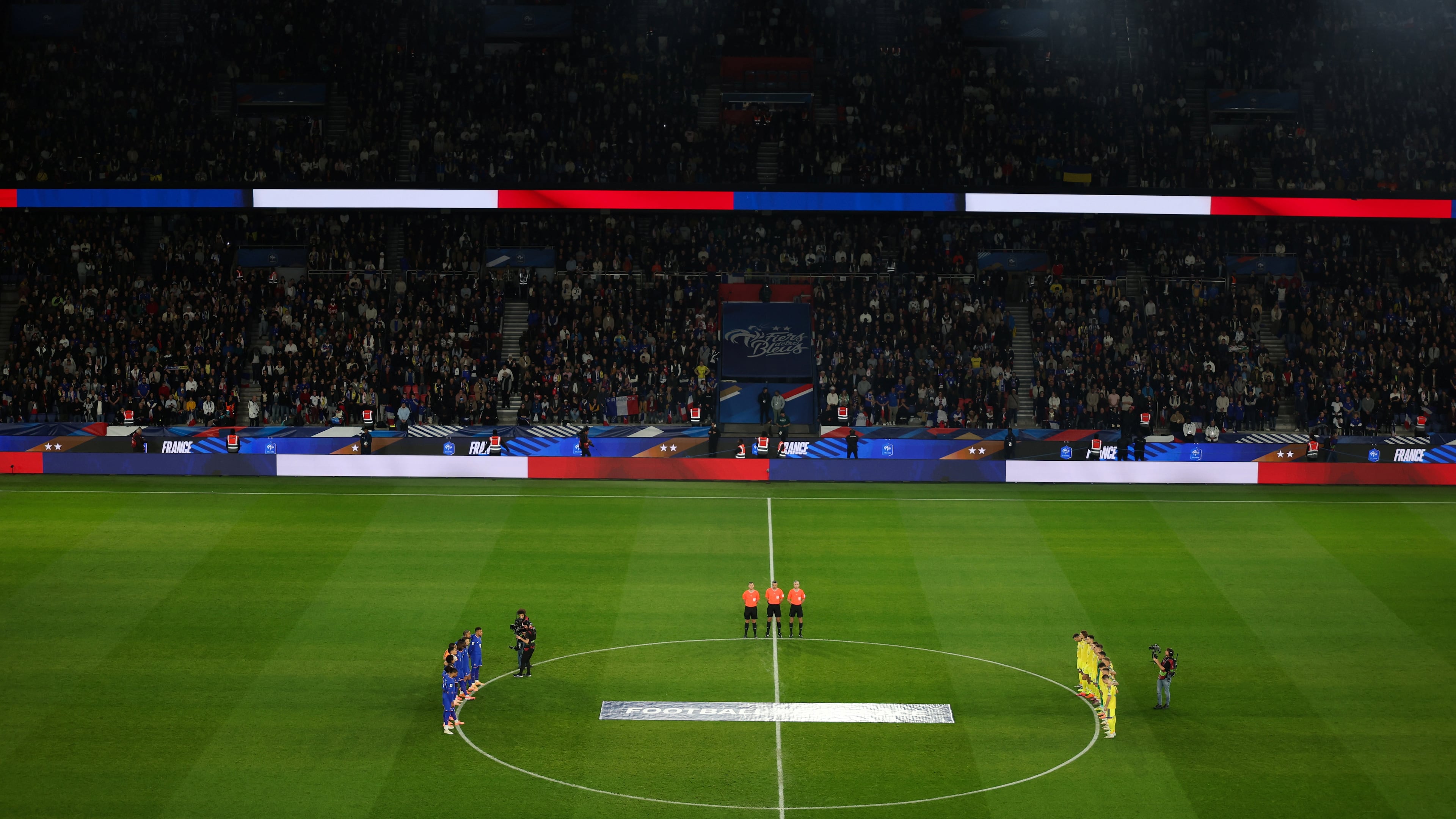 Ukrainian, right, and French players observe a minute of silence in tribute to the victims of the Nov.13, 2015 Paris attacks, ahead of the 2026 World Cup qualifiers Europe zone group D football match between France and Ukraine at the Parc des Princes stadium, Thursday, Nov. 13, 2025 in Paris. ( Franck Fife, Pool photo via AP)