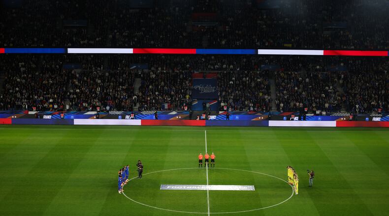 Ukrainian, right, and French players observe a minute of silence in tribute to the victims of the Nov.13, 2015 Paris attacks, ahead of the 2026 World Cup qualifiers Europe zone group D football match between France and Ukraine at the Parc des Princes stadium, Thursday, Nov. 13, 2025 in Paris. ( Franck Fife, Pool photo via AP)