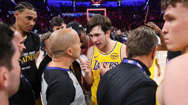 Los Angeles Lakers' Austin Reaves, center right, talks with referee John Goble, center, left, after the team's loss in Game 2 in a second-round NBA basketball playoffs series against the Oklahoma City Thunder Thursday, May 7, 2026, in Oklahoma City. (AP Photo/Nate Billings)