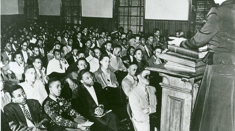 The Rev. Dr. Martin Luther King Jr., seated third from the left in the front row, listens attentively during a class as an undergraduate Morehouse College student. (AJC Files)