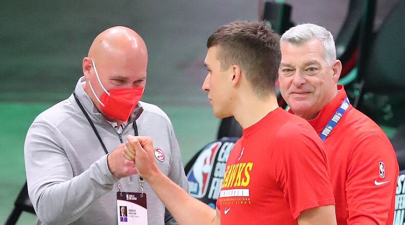062521 Milwaukee: Atlanta Hawks guard Bogan Bogdanovic gives general manager & president Travis Schlenk a fist bump with owner Tony Ressler looking on as he takes the court for warm ups before playing the Milwaukee Bucks in game 2 of the NBA Eastern Conference Finals on Friday, June 25, 2021, in Milwaukee.   “Curtis Compton / Curtis.Compton@ajc.com”