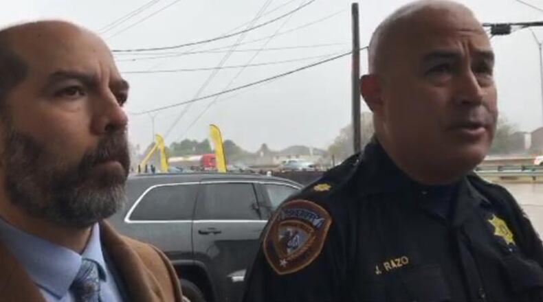 Harris County Sheriff's Office representatives speak to members of the press about a fatal drive-by shooting outside a Walmart near Houston on Sunday.