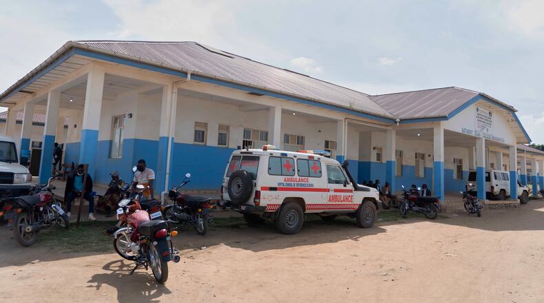 People wait near an ambulance at a hospital in Bunia, Congo, Sunday, May 17, 2026. (AP Photo/ Dirole Lotsima Dieudonne)