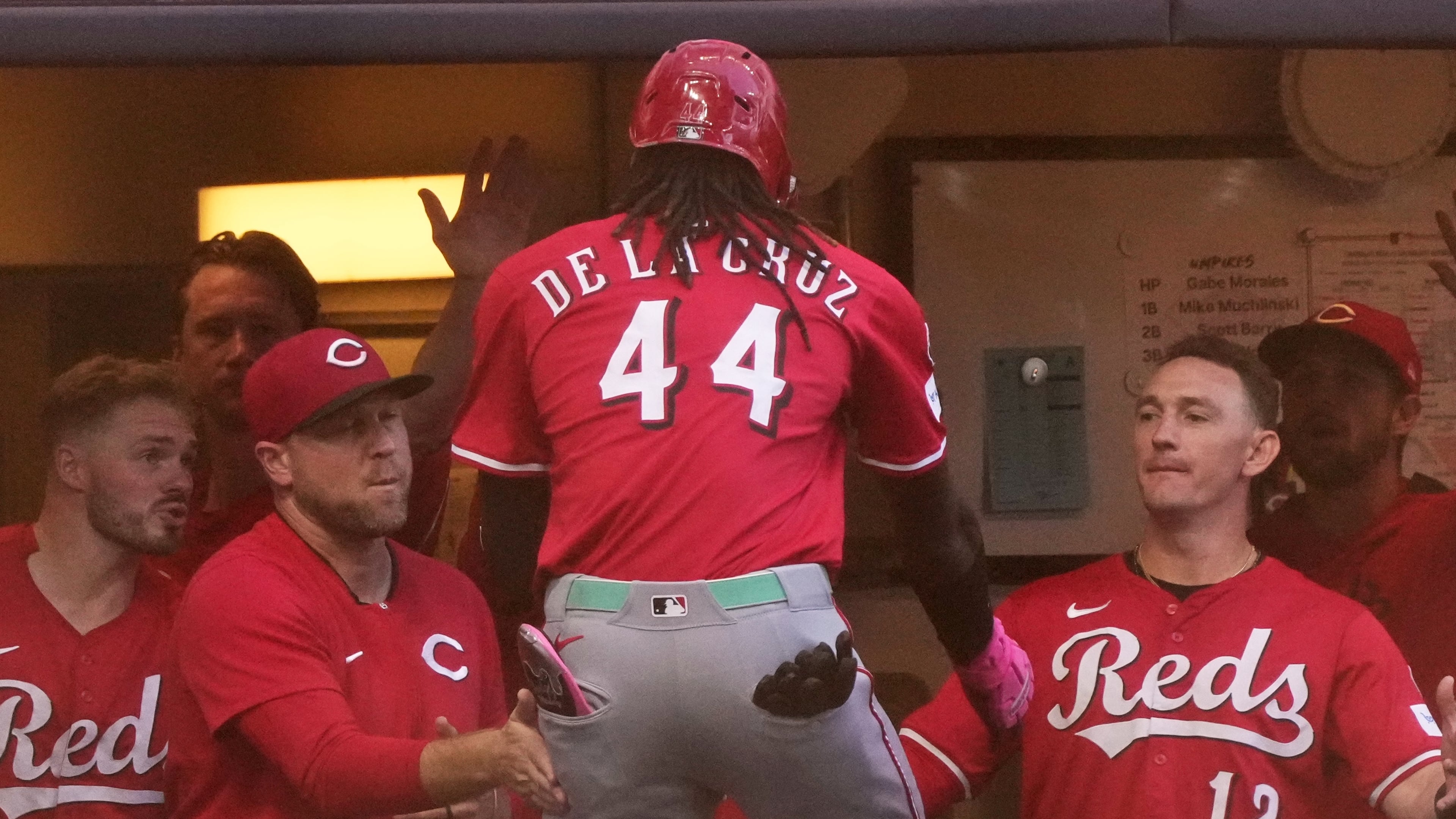 Cincinnati Reds' Elly De La Cruz is congratulated after hitting a home run during the second inning of a baseball game against the Milwaukee Brewers Sunday, Sept. 28, 2025, in Milwaukee. (AP Photo/Morry Gash)