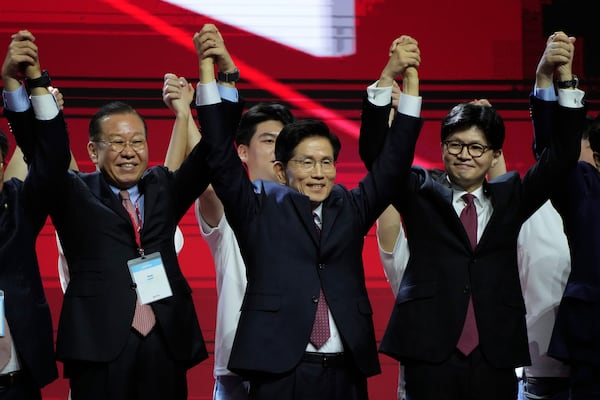 South Korea's former Labor Minister Kim Moon Soo, center, celebrates after winning the nomination as the presidential election candidate during the People Power Party's convention in Goyang, South Korea, Saturday, May 3, 2025. (AP Photo/Ahn Young-joon)