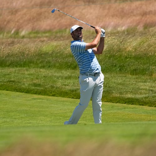 Scottie Scheffler watches his shot on the 13th hole during a practice round for the U.S. Open golf tournament at Shinnecock Hills Golf Club in Southampton, N.Y., Monday, June 15, 2026.(AP Photo/David J. Phillip)
