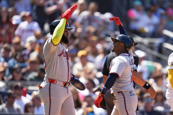 Braves second baseman Ozzie Albies (right) celebrates with teammate Marcell Ozuna after hitting a two-run homer.