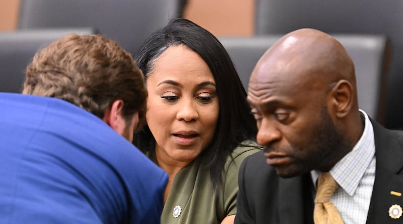 Fulton DA Fani Willis, center, confers with lead prosecutors, Donald Wakeford, left, and Nathan Wade, during a hearing at the Fulton County Courthouse in Atlanta on July 1, 2022. (Hyosub Shin/The Atlanta Journal-Constitution/TNS)