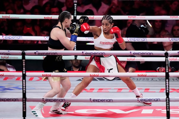 Puerto Rico's Amanda Serrano, right, punches Ireland's Katie Taylor during the second round of a super lightweight championship boxing match Friday, July 11, 2025, in New York. (AP Photo/Frank Franklin II)