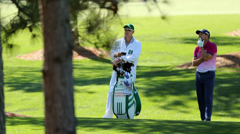 April 8, 2017 AUGUSTA Sergio Garcia and caddie Glenn Murray, check his shot from the woods on the 7th hole. Play begins in the third round of the 81st Masters tournament at the Augusta National Golf Club, Saturday, April 8, 2017. CURTIS COMPTON/ AJC