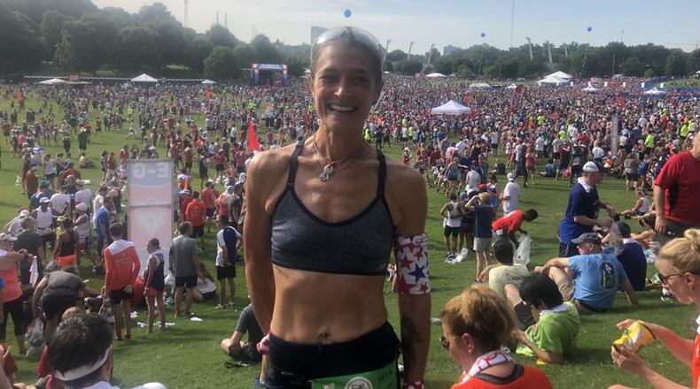Dana Greene ran the 50th AJC Peachtree Road Race on Thursday, a year after suffering a heart attack.
