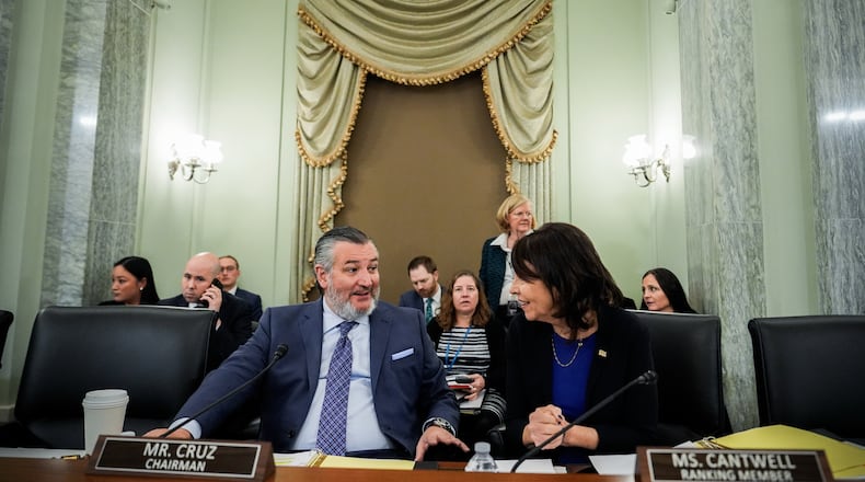 FILE - Sen. Ted Cruz, R-Texas, left, chairman of the Senate Commerce, Science and Transportation Committee, speaks with Sen. Maria Cantwell, D-Wash., right, before a hearing Wednesday, Nov. 19, 2025, on Capitol Hill in Washington. (AP Photo/Julia Demaree Nikhinson,File)