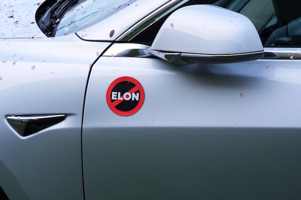A Tesla vehicle displays an anti-Elon Musk sign near a protest against Tesla and Elon Musk outside a service center Saturday, March 29, 2025, in Seattle. (AP Photo/Lindsey Wasson)