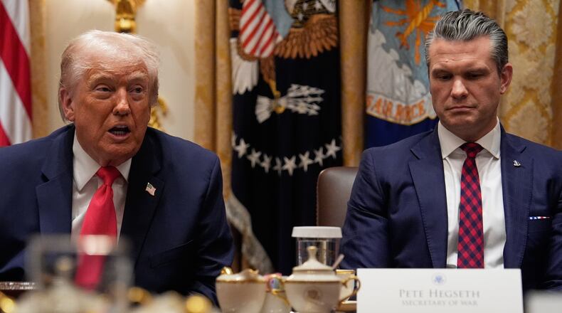 President Donald Trump speaks during a Cabinet meeting at the White House, Tuesday, Dec. 2, 2025, in Washington, as Secretary of Defense Pete Hegseth looks on. (AP Photo/Julia Demaree Nikhinson)