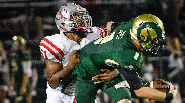 Grayson QB Chase Brice (2) is brought down by Archer DE Irvin Santos during the first half of Friday's game.
