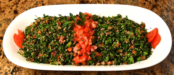 Tabbouleh, a bulgur salad, is a part of the meal that brings back memories for Hala Yassine: “Growing up, we would gather the parsley, mint and tomatoes for the tabbouleh and warak enab, stuffed grape leaves. It was a fun thing to do. We hunted. We gathered. We made.” (Styling by Farrah Haidar and Hala Yassine / Chris Hunt for the AJC)