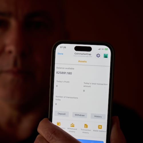 Chris Colocousis holds up a screenshot of the fake app where he invested his savings showing his account had more than doubled to nearly $826,000 as part of a scam in which he says he lost $400,000 at his home in Raynham, Mass., Tuesday, March 10, 2026. (AP Photo/David Goldman)