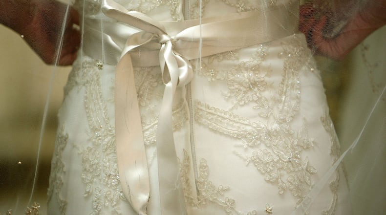 Maggie McElhannon sports a Casablanca bridal dress at Wedding Angels Bridal Boutique in Roswell.