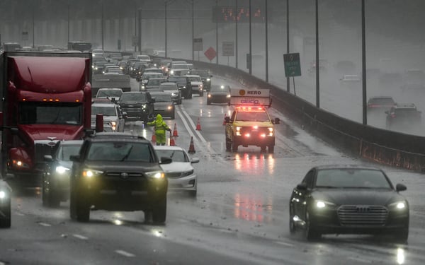 Two left lanes were blocked on I-75 North at Moores Mill Road due to flooding on Saturday, Sept. 12, 2026. (Ben Hendren for the AJC)