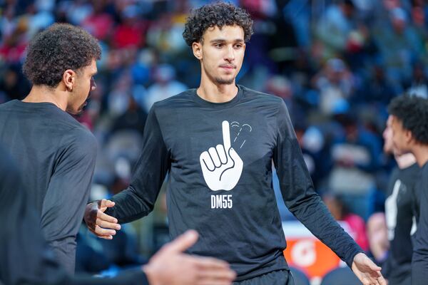 Hawks rookie Zaccharie Risacher wears a warm-up shirt honoring the late Dikembe Mutombo and his signature finger wave.