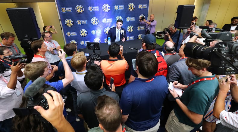 Georgia quarterback Stetson Bennett is surrounded by news media for his press conference at SEC Media Days in the College Football Hall of Fame on Wednesday, July 20, 2022, in Atlanta.   “Curtis Compton / Curtis Compton@ajc.com”