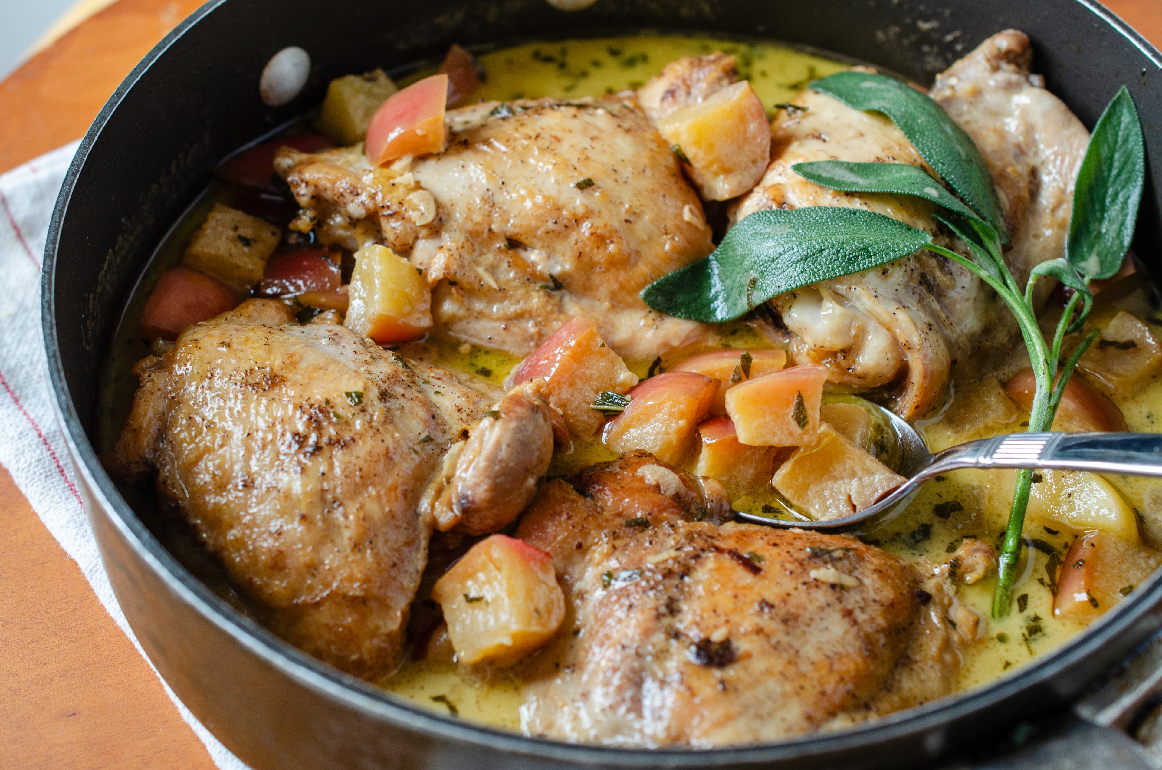 French Chicken with Apples and Cream is rich and indulgent with chunks of apples bobbing in a cream-enriched jus. (Virginia Willis for the AJC)