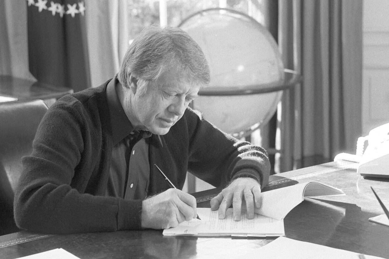 President Carter works at his desk in the Oval Office on February 8, 1977. (Jimmy Carter Library)