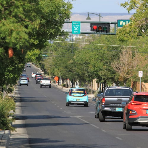 Vehicles stop along Lead Avenue where stoplights are set for a specific speed limit as part of the "rest on red" signal program in Albuquerque, N.M., Wednesday, Aug. 12, 2026. (AP Photo/Susan Montoya Bryan)