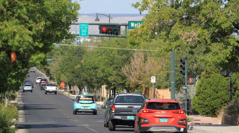 Vehicles stop along Lead Avenue where stoplights are set for a specific speed limit as part of the "rest on red" signal program in Albuquerque, N.M., Wednesday, Aug. 12, 2026. (AP Photo/Susan Montoya Bryan)