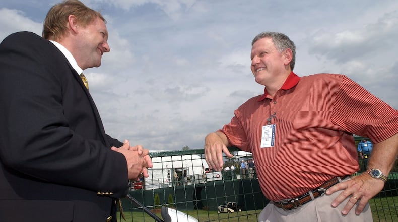 BellSouth Classic Tournament Director Dave Kaplan, right, talks with TPC Sugarloaf General Manager Doug Meredith behind the 18th scoring area during round 2 of the BellSouth Classic at TPC at Sugarloaf in Duluth, Ga., March 31, 2006. (Jason Getz/AJC staff)