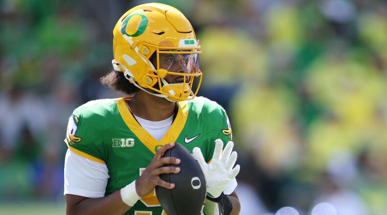 Oregon quarterback Dante Moore (5) looks to pass during the first half of an NCAA college football game against Boise State, Saturday, Sept. 5, 2026, in Eugene, Ore. (AP Photo/Lydia Ely)