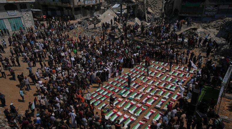 Bodies of members of the Hassayna and Abu Sharia families, killed in an Israeli strike in 2023 and recently recovered from the rubble, are draped in Palestinian flags during their funeral in Gaza City, Tuesday, Aug. 4, 2026. (AP Photo/Jehad Alshrafi)
