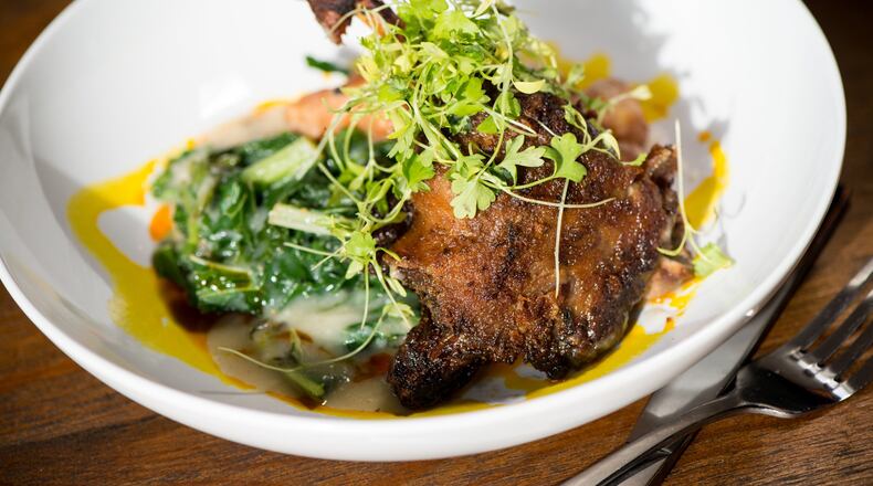 Duck and dumplings with duck confit, sweet potato dumpling, country cream gravy, and winter greens. Photo credit- Mia Yakel.