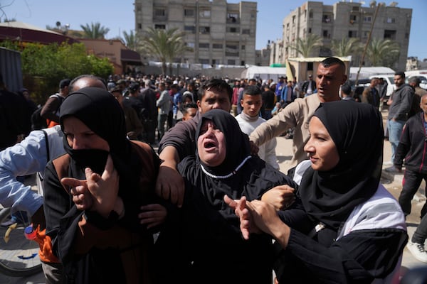 Mourners react during the funeral of 8 Red Crescent emergency responders, recovered in Rafah a week after an Israeli attack, in Deir al-Balah, Gaza Strip, on Monday, March 31, 2025. (AP Photo/Abdel Kareem Hana)