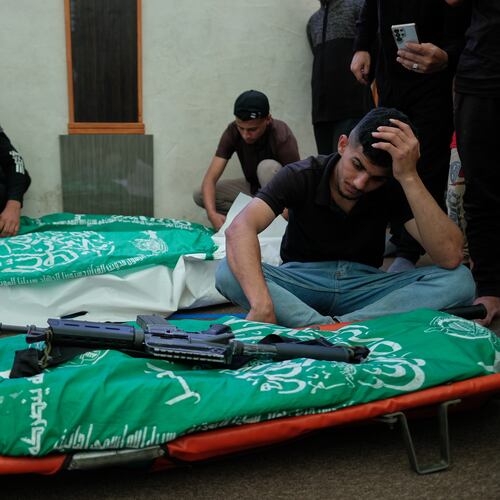 Palestinians mourn over the bodies of Hamas militant Imad Isleim, foreground, his wife and daughter, who were killed in an Israeli military strike, during their funeral at Al-Shafi'i Mosque in Gaza City, Thursday, May 28, 2026. (AP Photo/Jehad Alshrafi) CORRECTION: Corrects surname from al-Salem to Isleim