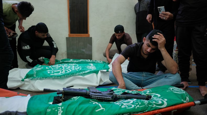 Palestinians mourn over the bodies of Hamas militant Imad Isleim, foreground, his wife and daughter, who were killed in an Israeli military strike, during their funeral at Al-Shafi'i Mosque in Gaza City, Thursday, May 28, 2026. (AP Photo/Jehad Alshrafi) CORRECTION: Corrects surname from al-Salem to Isleim