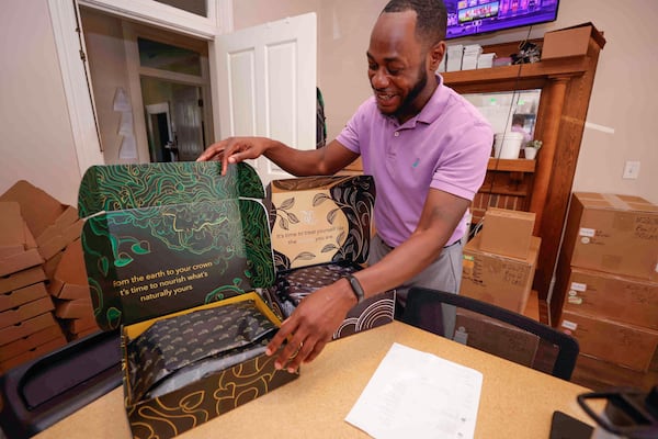 Operations Manager Richard Skinner opens an Ecoslay Terrasol bundle package at the company’s headquarters. (Natrice Miller/ AJC)