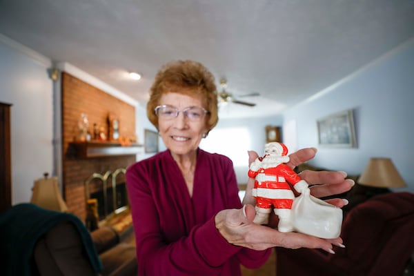 Marie George Myers still has the Santa Claus figure given to her by a customer she delivered papers to in the early 1960s. (Miguel Martinez/AJC)
