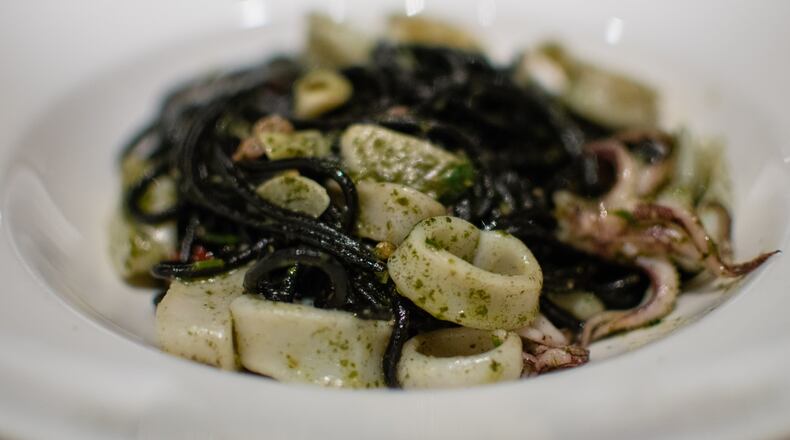 Squid ink spaghetti with calamari, Calabrian chiles and Thai basil pesto at La Tavola Trattoria. CONTRIBUTED BY HENRI HOLLIS