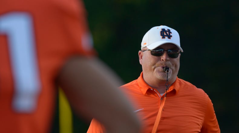 Kennesaw, Ga. -- North Cobb head coach Shane Queen runs the Warriors through their pre-game warm up before their game against McEachern at North Cobb Friday, October 6, 2017. Special/Daniel Varnado