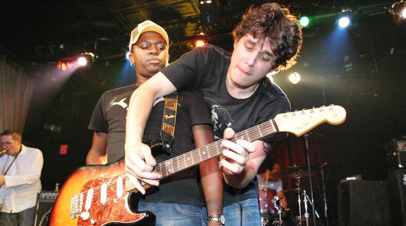 John Mayer offers an assist to David Ryan Harris at Smith's Olde Bar in this file photo. Robb Cohen Photography & Video/www.RobbsPhotos.com. Go here to read our Personal Journey marking Robb Cohen's 1000th concert shoot for the AJC, and see hundreds of photos from our archive.