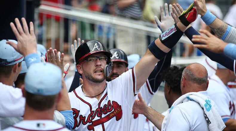 Tyler Flowers gets high fives in the dugout after hitting a 2-RBI home run to take a 4-1 lead over the San Diego Padres during the eighth inning in a MLB baseball game on Sunday, June 17, 2018, in Atlanta. Curtis Compton/ccompton@ajc.com