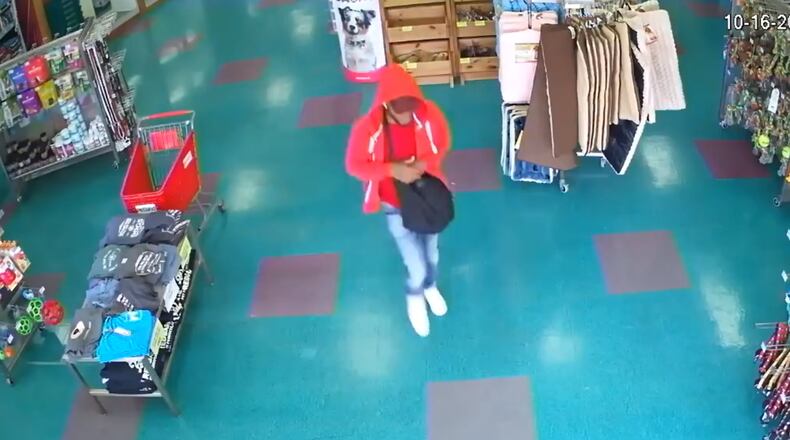 The suspect walked out of the pet store with a French bulldog in his bag.