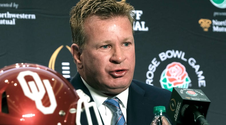 Mike Stoops at the microphone.