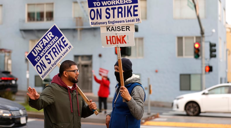 Kaiser Permanente union workers hold on strike signs during an informational picket outside of the Kaiser Permanente San Francisco Medical Center on Nov. 10, 2021 in San Francisco. (Justin Sullivan/Getty Images/TNS)
