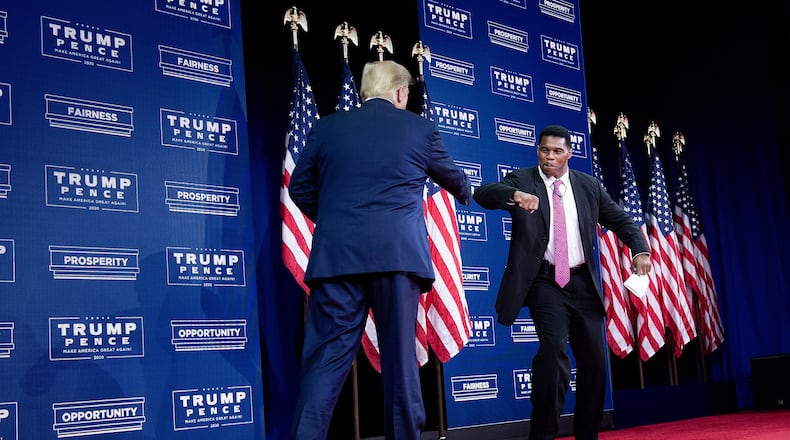 President Donald Trump is greeted by NFL Hall of Famer Herschel Walker during an event for black supporters at the Cobb Galleria Centre in Atlanta on September 25, 2020. (Brendan Smialowski/AFP via Getty Images/TNS)