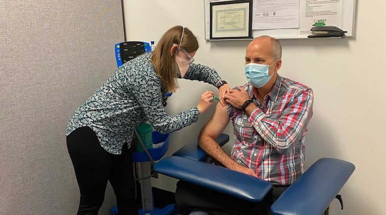 Emory University's Betsy Hall gives a shot to study participant John Arnold for a potential COVID-19 vaccine. Emory is one of several sites nationwide conducting research of a COVID-19 vaccine developed by Novavax, a biotech company based in Maryland. EMORY UNIVERSITY